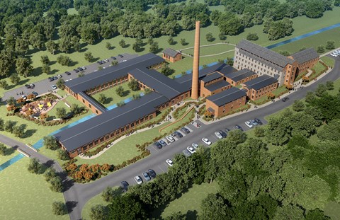 an aerial view of a large building with a smokestack