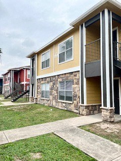 a row of houses with a sidewalk and grass