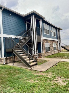 a blue house with stairs in front of it