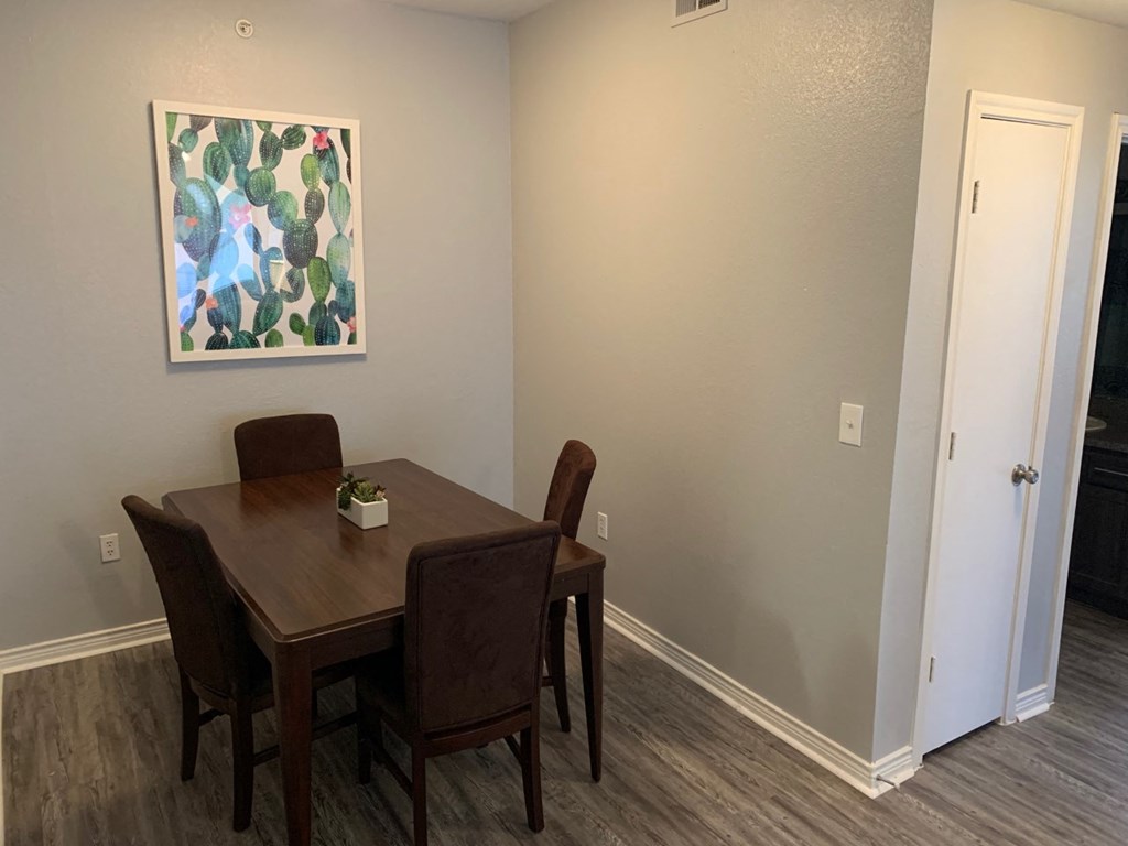 a dining room with a table and chairs