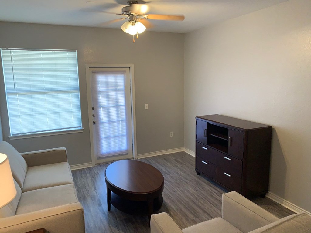 an empty living room with a couch and a table