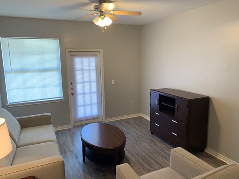 an empty living room with a couch and a table