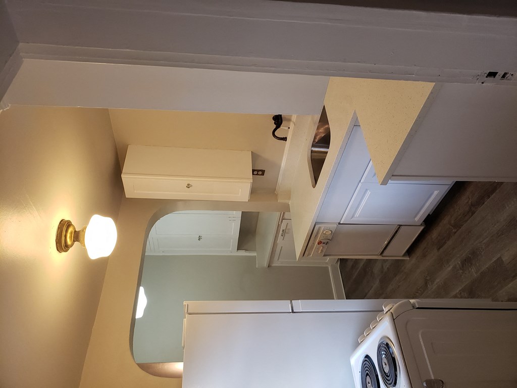 a small kitchen with a washer and dryer and a window