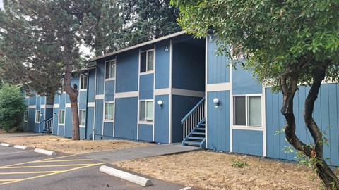 A blue building with a white door and windows.