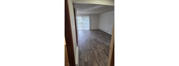 A room with a slanted ceiling and wood flooring.