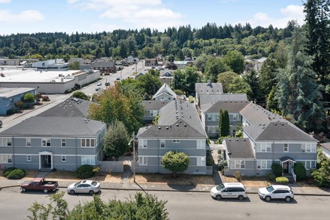 an aerial view of a neighborhood of houses with cars parked in front of them