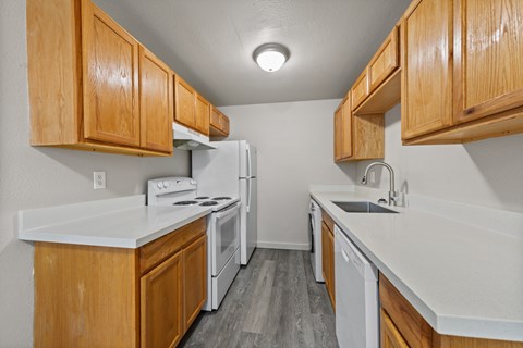 A kitchen with wooden cabinets and white appliances.