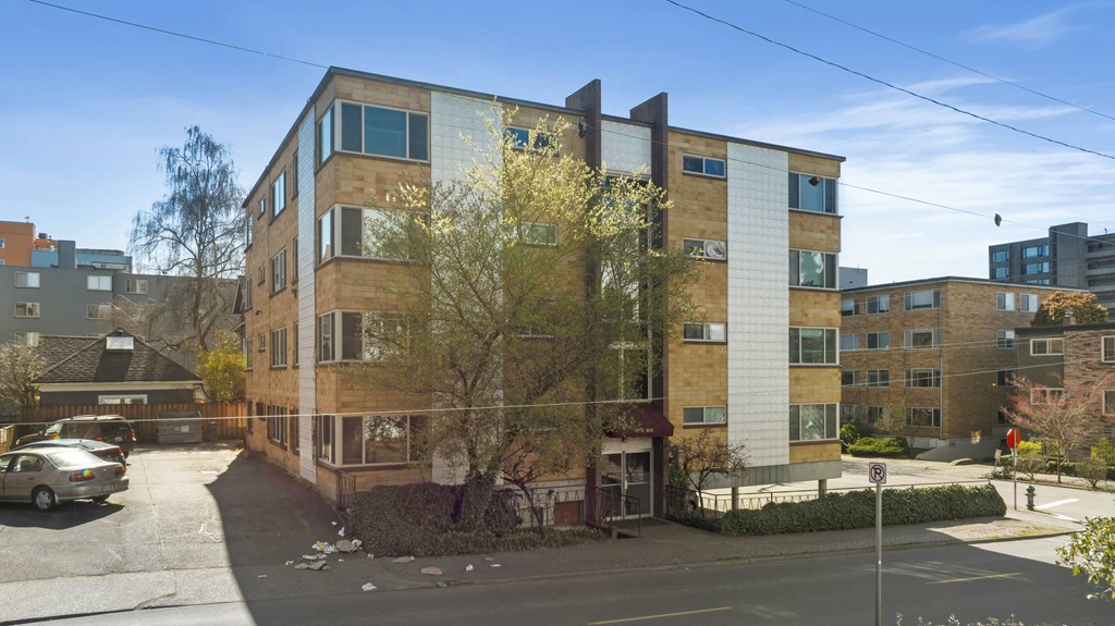 an apartment building on the corner of a city street