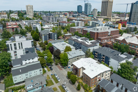 A cityscape with buildings of various sizes and a clear sky.