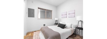 A bedroom with a bed, nightstand, and two lamps.