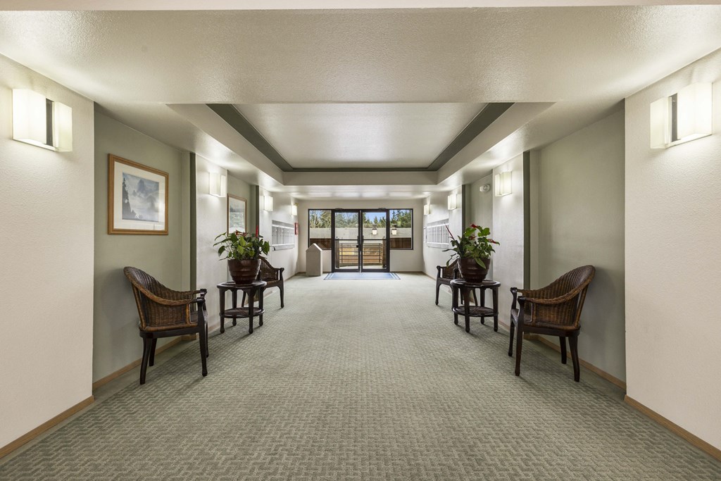 a large hallway with chairs and tables and a doorway