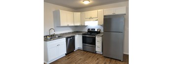 Bridgeport Terrace's Studio kitchen with white cabinets and stainless steel appliances.