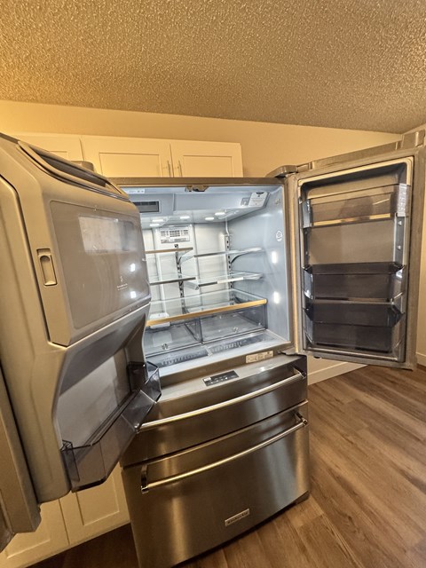 A stainless steel refrigerator in 2-bedroom apartment kitchen at Bridgeport Terrace Apartments.