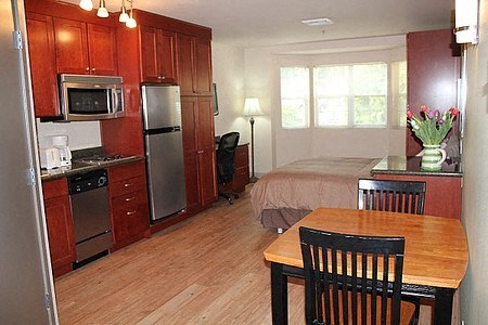 a kitchen with a table and a bed