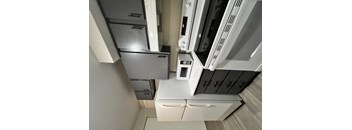 A kitchen with white appliances and cabinets.