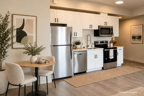 A modern kitchen with a table and chairs.