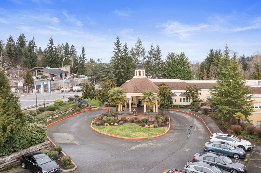 an aerial view of a building with cars parked in front of it