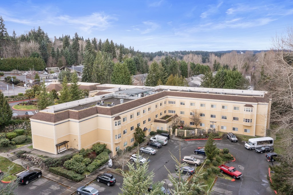 an aerial view of an office building with cars parked in a parking lot