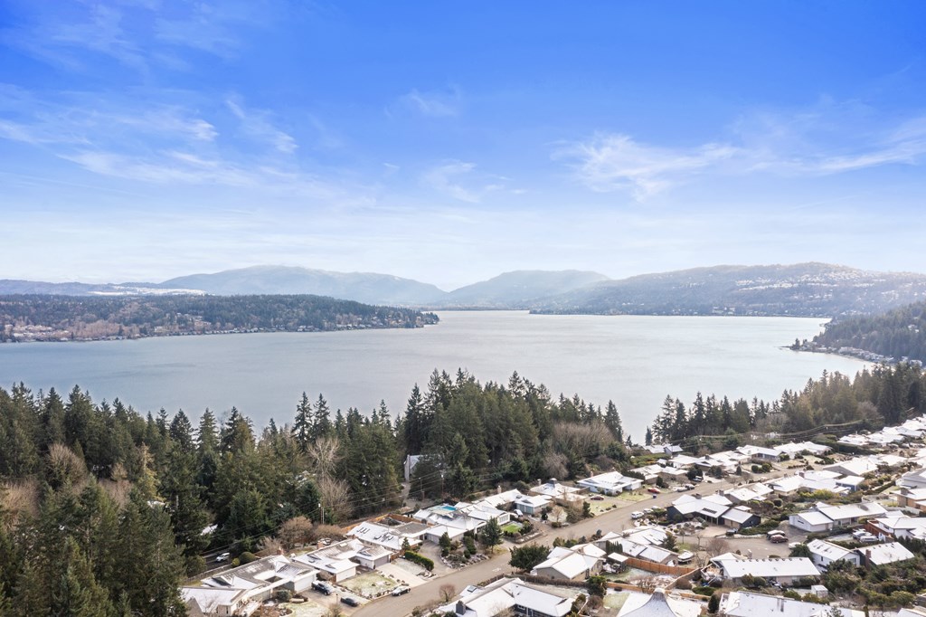 a city with a lake and mountains in the background