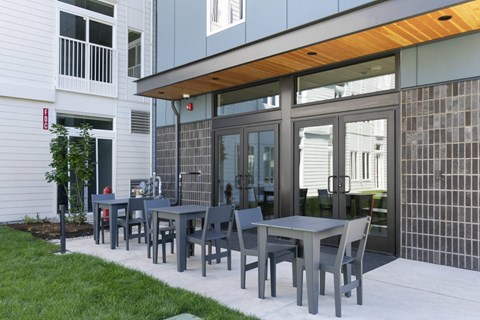 Outdoor patio with seating and covered overhang at The Hub Apartments, Lacey, WA 98503