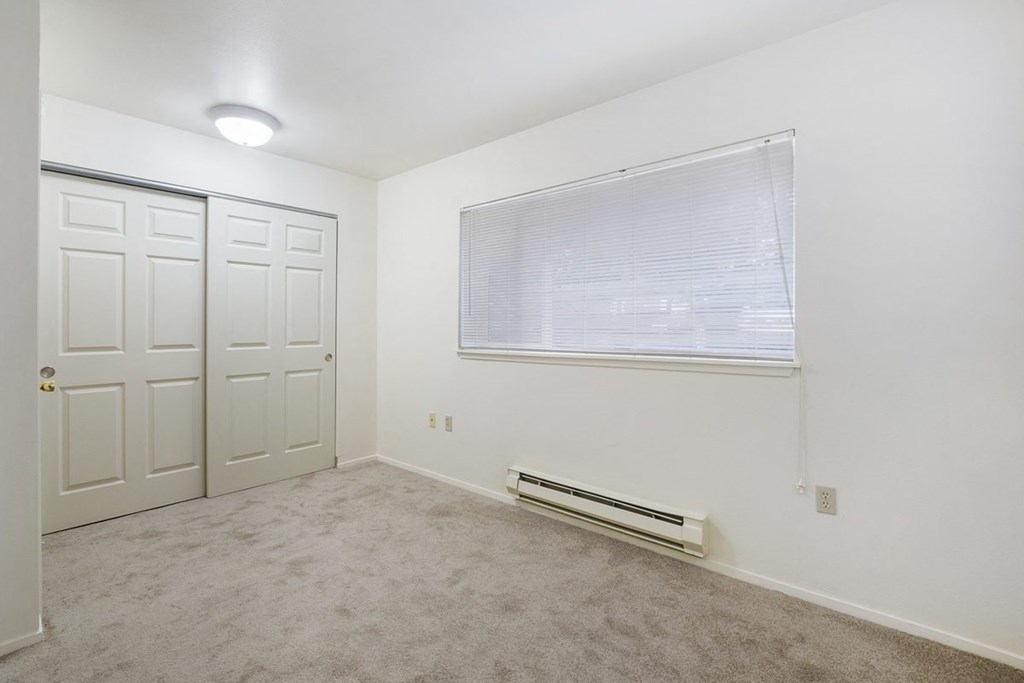 an empty room with a window and a door