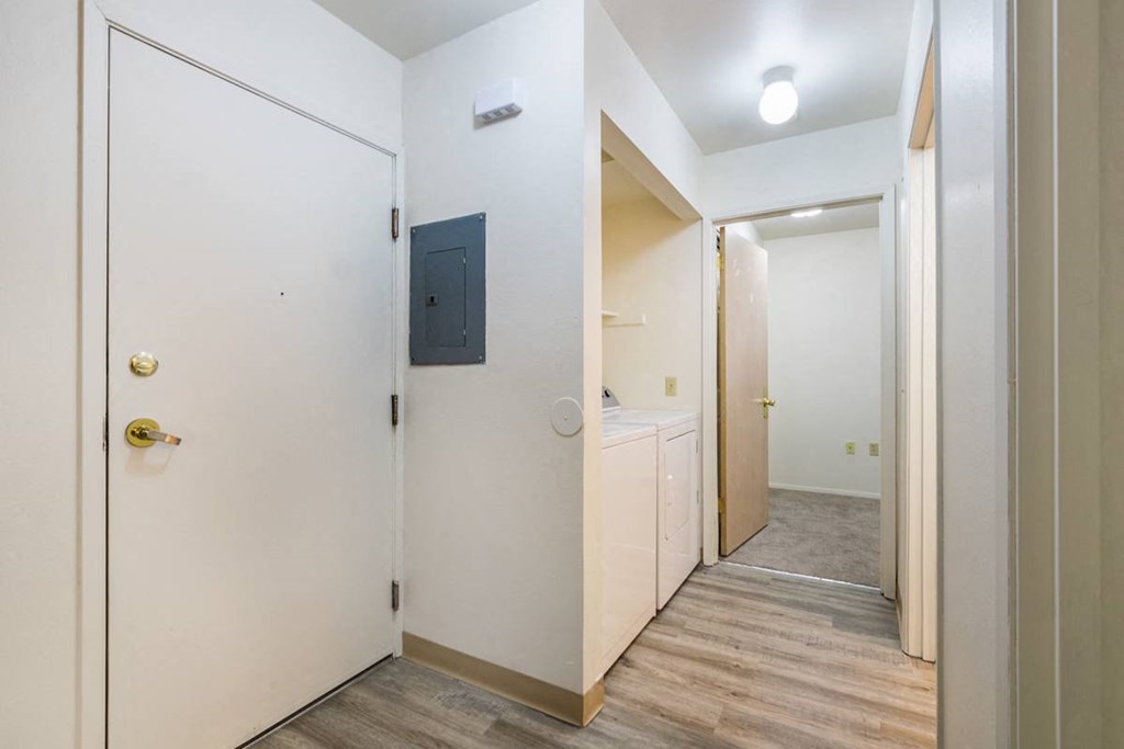 a hallway with white doors and a door to a bathroom