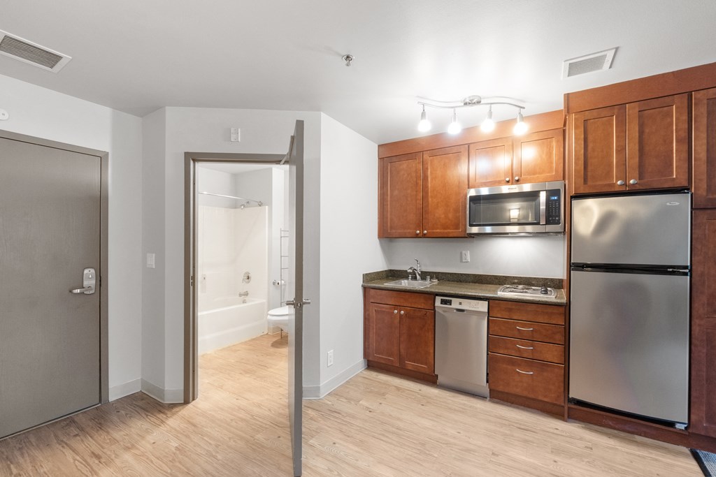 a kitchen with wooden cabinets and stainless steel appliances