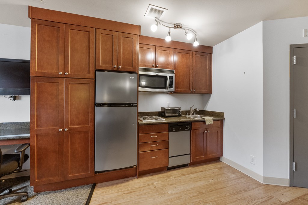 a kitchen with stainless steel appliances and wooden cabinets