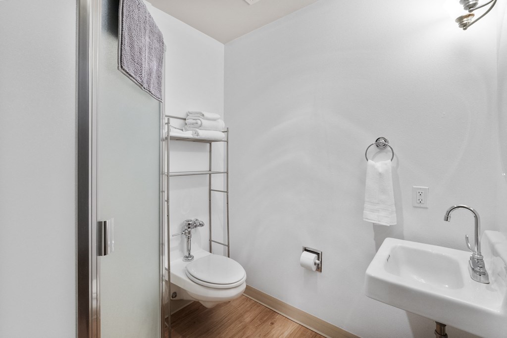 a bathroom with a toilet and a sink and a shower