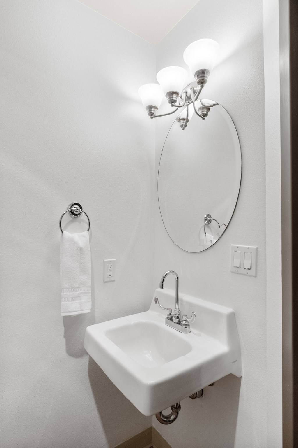 a small bathroom with a sink and a mirror