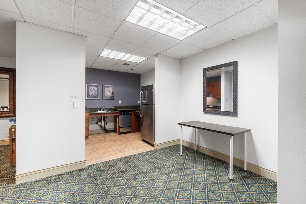 a room with a table and a mirror in a room