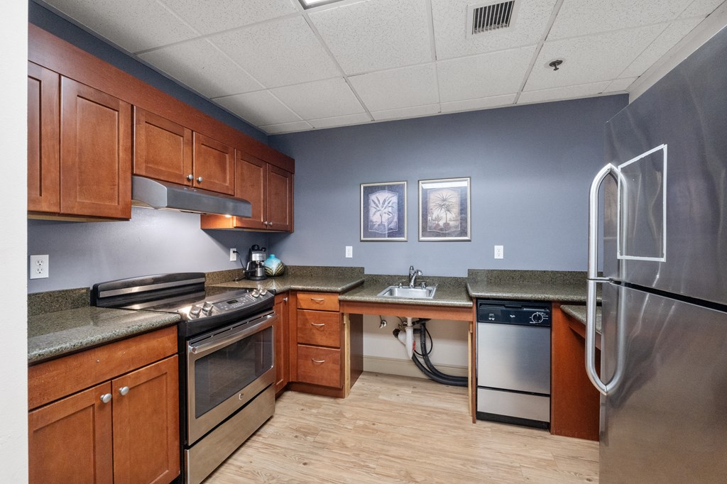 a kitchen with wooden cabinets and stainless steel appliances