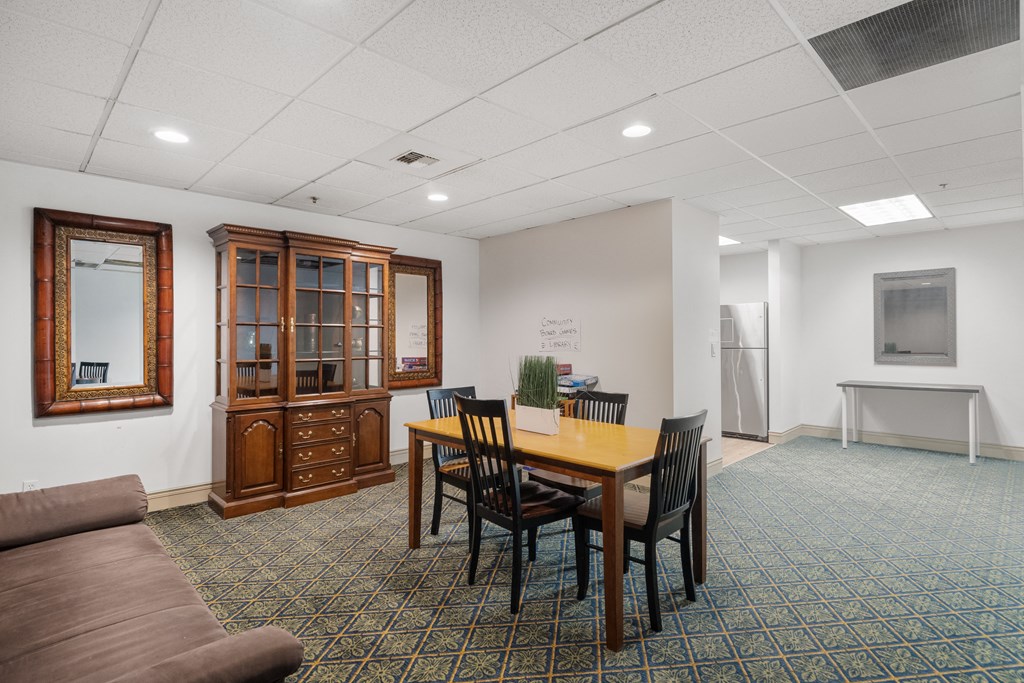a conference room with a table and chairs and a couch