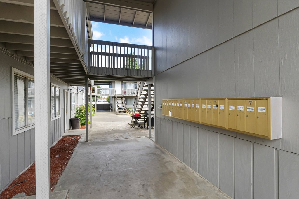 a hallway with a staircase leading up to an apartment building