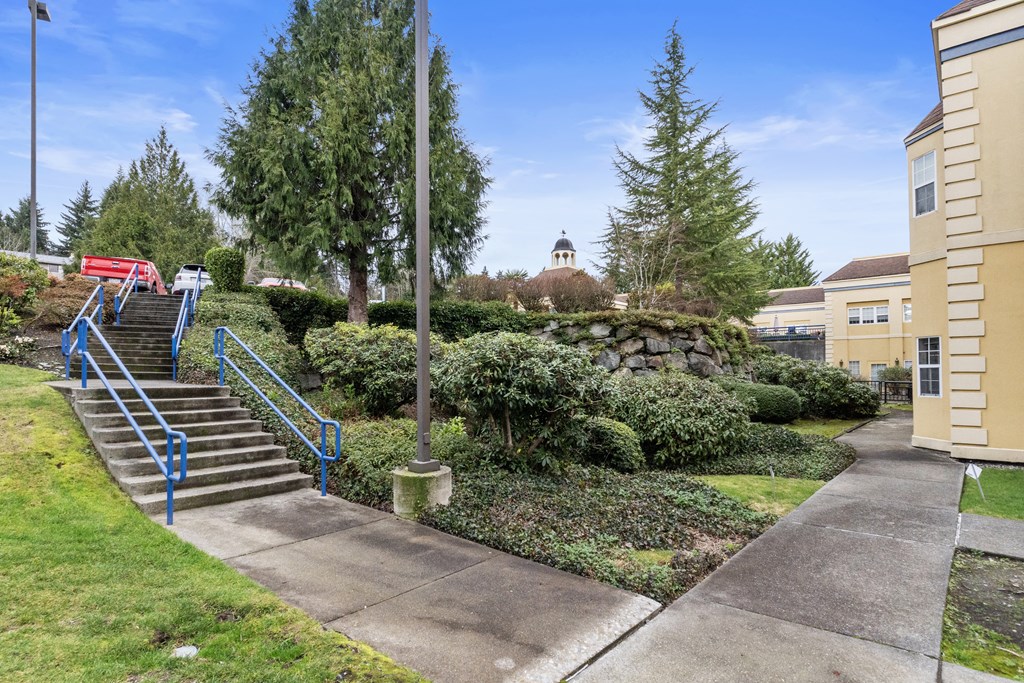 a staircase leading up to a building with stairs and a sidewalk