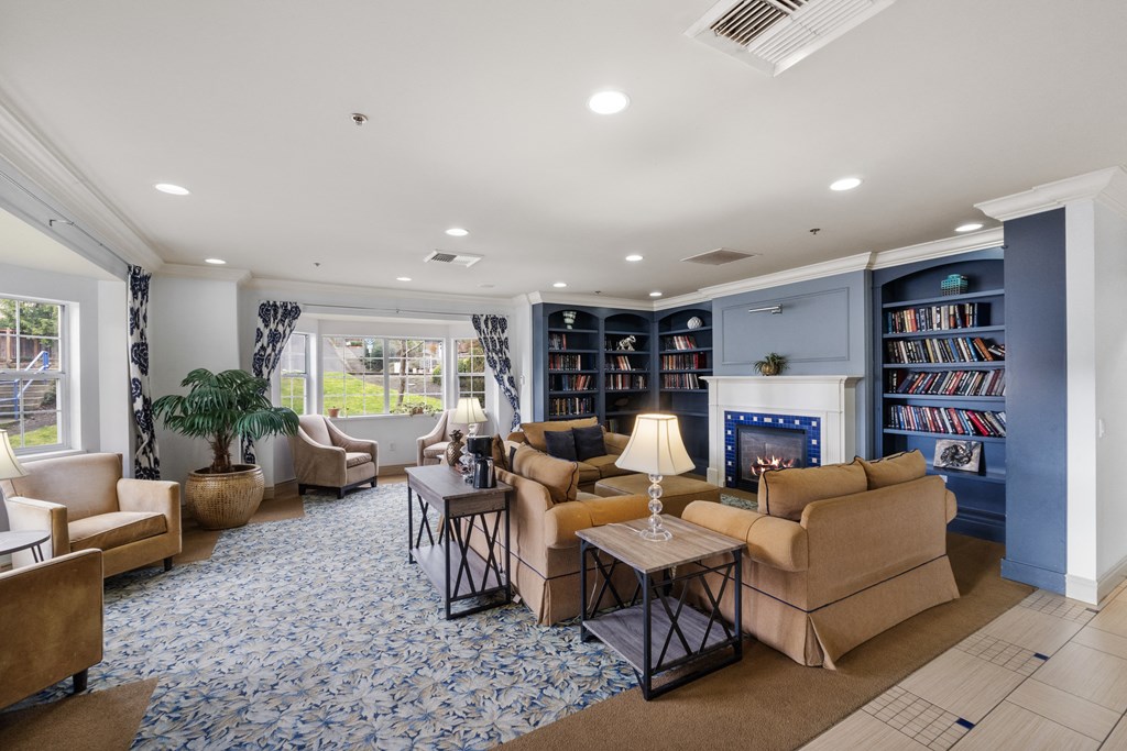 a living room with couches and chairs and a fireplace