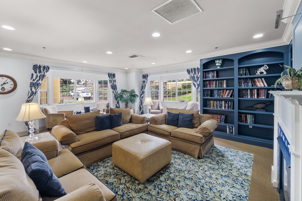 a living room with couches and a bookshelf