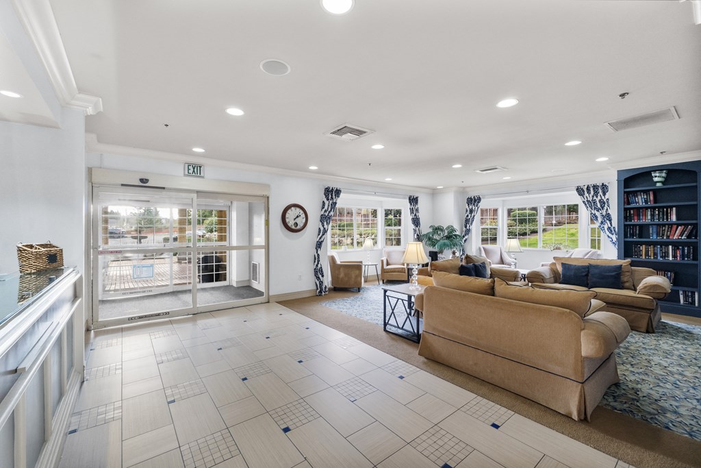 a living room with couches and a fireplace and a window