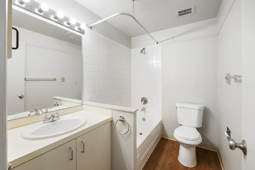 a small bathroom with a sink toilet and shower