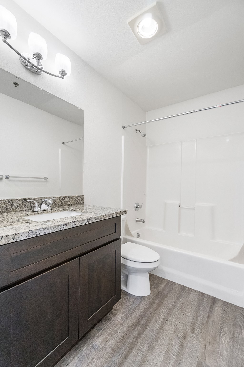 a bathroom with a toilet and a sink and a bath tub
