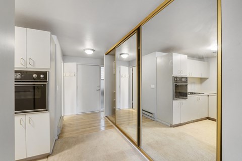 a renovated kitchen with white cabinets and stainless steel appliances