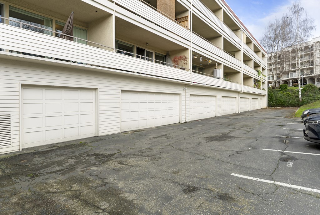 an empty parking lot in front of an apartment building