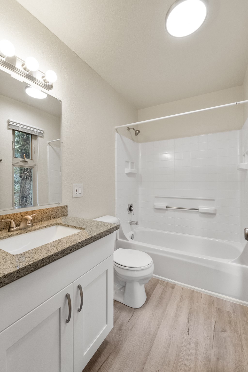 a bathroom with a sink and a toilet and a bath tub