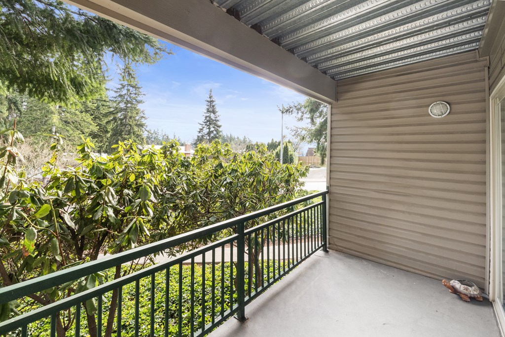 a balcony with a view of a yard and a house