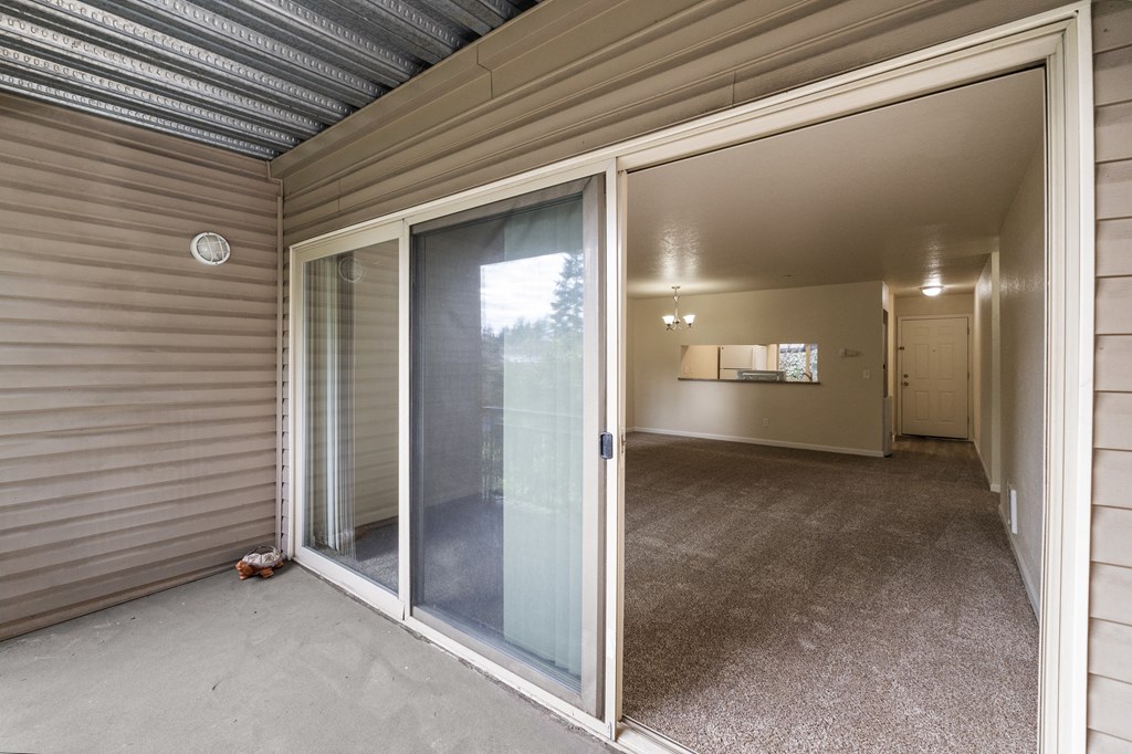 a sliding glass door is open to a room in a home