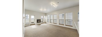 Spacious living with fireplace and large windows