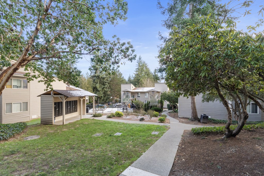 a neighborhood with houses and trees and a sidewalk