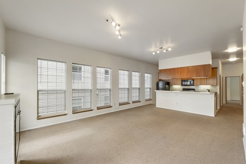 A spacious room with a long counter and windows on the side.