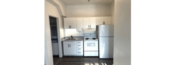Kitchen with white appliances, cabinets, and countertops in Olympia WA apartment