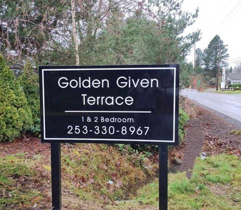 A sign for Golden Given Terrace with a phone number for a 1 and 2 bedroom option.
